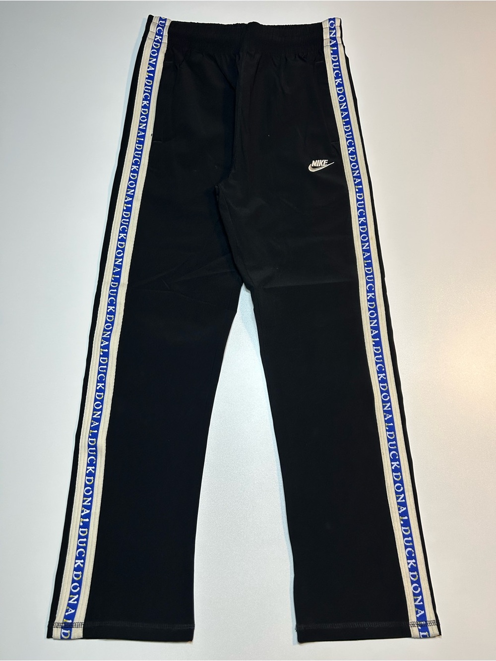 Nike NSW Repeat Poly Track Pants Black Donald Duck Logo Side Tape Joggers